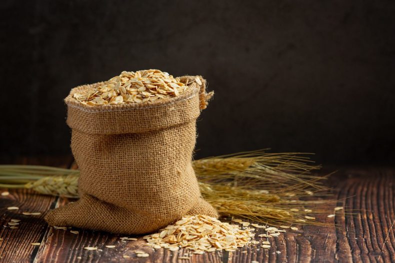 raw barley grain in wooden background