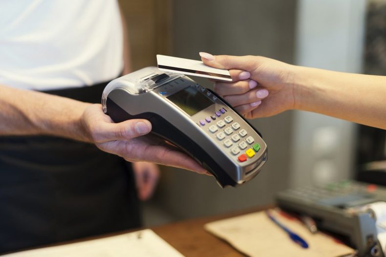 Close up of customer paying by credit card
